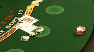 The dealer is hitting the players hand on a handheld deck The dealer is hitting the players hand on a handheld deck
