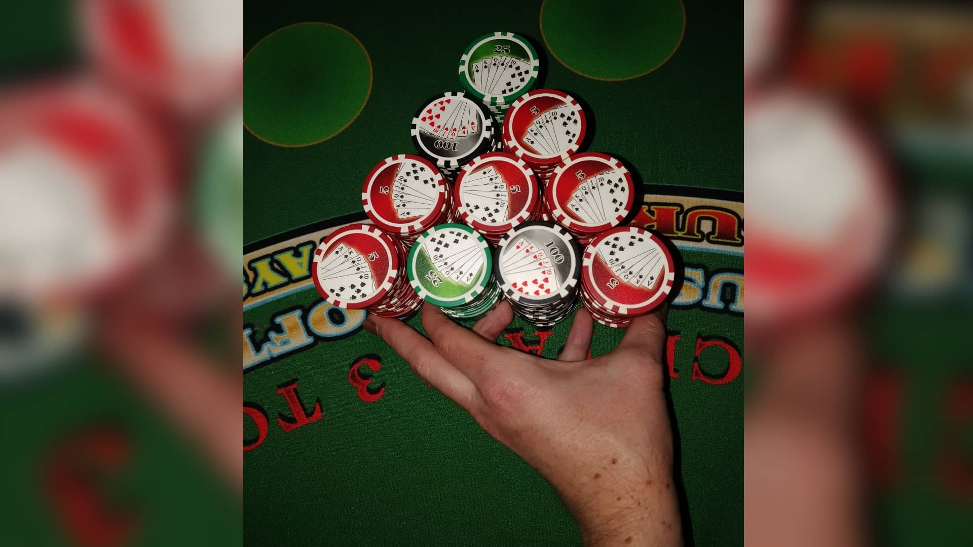 The dealer is pushing 2 stacks of roulette chips The dealer is pushing 2 stacks of roulette chips