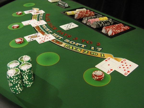 A large stack of green chips on the player's side of blackjack A large stack of green chips on the player's side of blackjack