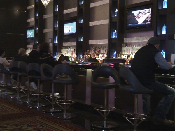People are sitting at a bar People are sitting at a bar