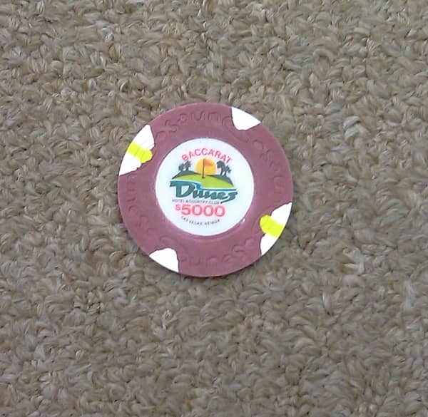 A 5,000 dollar chip lying on the carpet A 5,000 dollar chip lying on the carpet