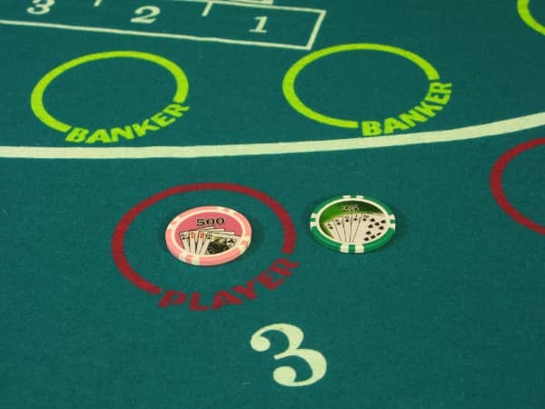 There is a five hundred dollar bet on Player along with a twenty five dollar toke next to it on a mini-baccarat table There is a five hundred dollar bet on Player along with a twenty five dollar toke next to it on a mini-baccarat table