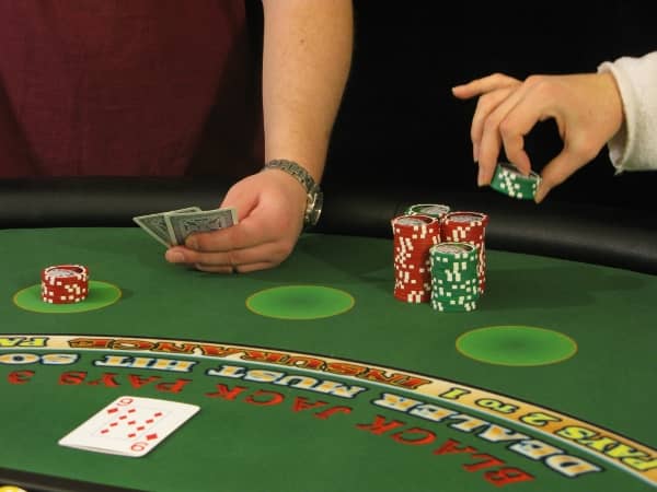 A woman is stealing chips from the player A woman is stealing chips from the player