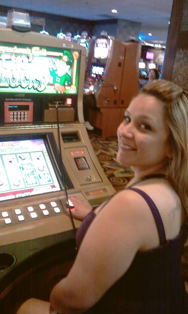 A pretty woman playing a slot machine A pretty woman playing a slot machine