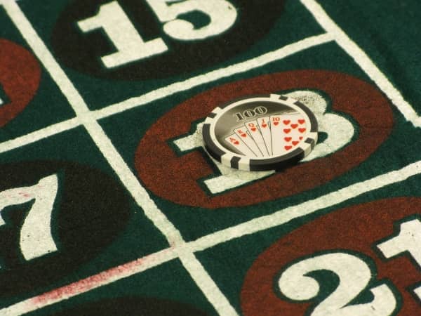 A hundred dollar chip on the number 18 on roulette A hundred dollar chip on the number 18 on roulette