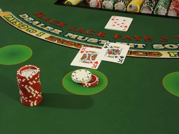 A blackjack bet that has two dollars heeled on top of it A blackjack bet that has two dollars heeled on top of it