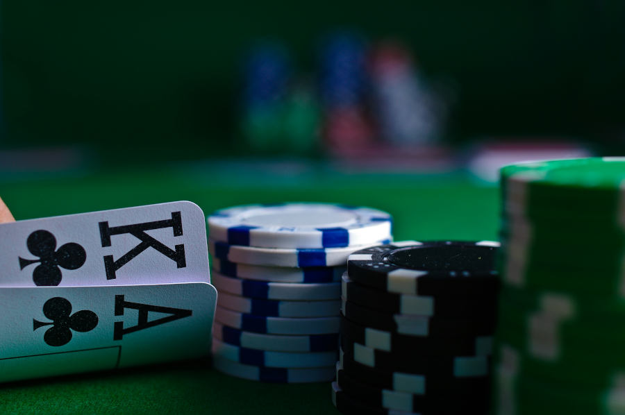 a king and ace of cards next to casino chips